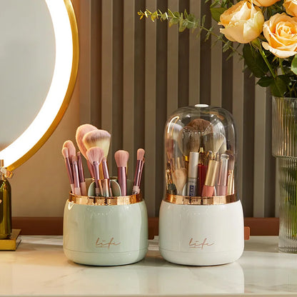 360° Rotating Makeup Brush Storage Box beside an open brush holder, mirror and yellow roses