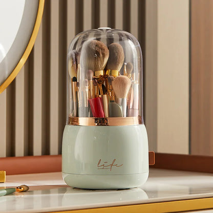 360° Rotating Makeup Brush Storage Box with a white base and assorted brushes under a clear dome