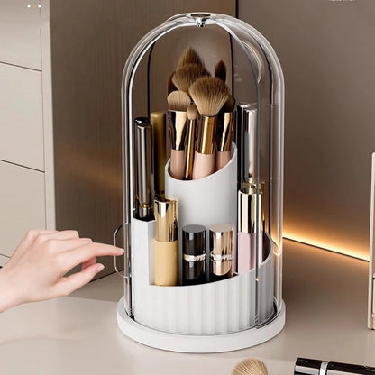Hand pointing to a white 180° Rotating Cosmetic Storage Box filled with brushes and bottles